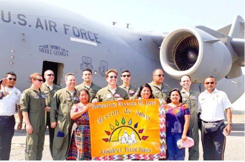 A group of people standing in front of a u.s. air force plane