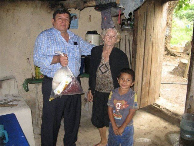 Julio delivering our Mission of LOVE Aid to this Grandmother and child in Honduras. Take a real look at the interior of the home.