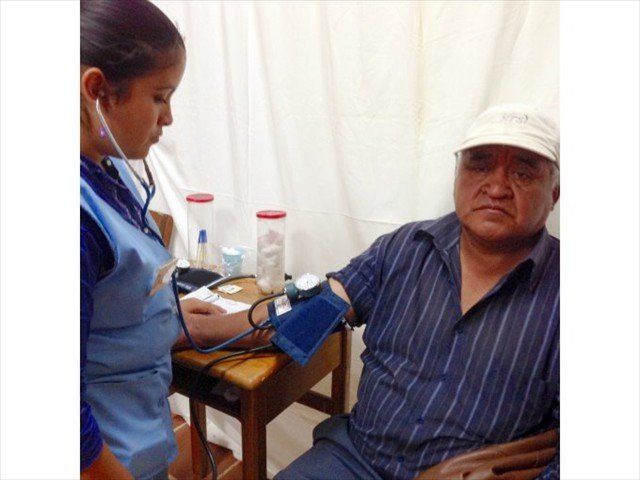 NURSE VOLUNTEER DEANA TENDING TO PATIENT AT WAY-BI, GUATEMALA.