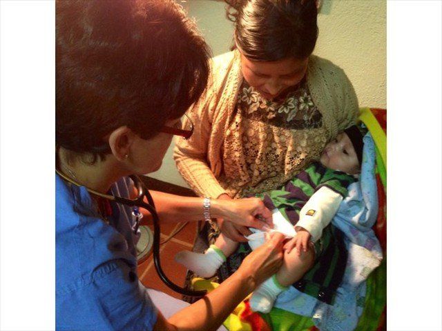 MAYAN MOTHER AND CHILD BEING EXAMINED BY DOCTOR KATHIE NELSON @ WAY-BI CLINIC.