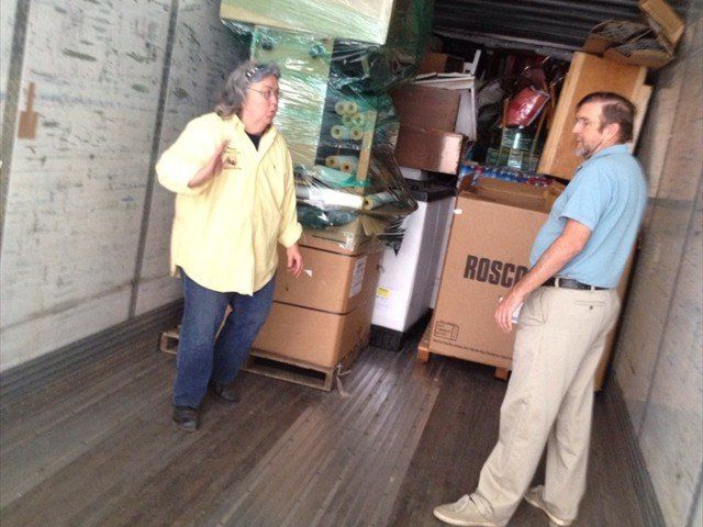 A man and a woman standing inside of a rosco truck at Pine Ridge Reservation