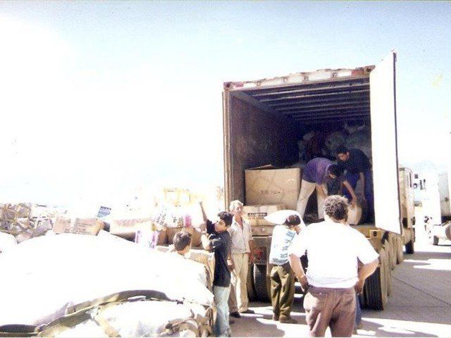 Julio is offloading the Mission of Love Denton Aid from the Air Force Pallets onto the trucks to be sorted and labeled as to what community in Honduras this Mission of Love Aid will go to.