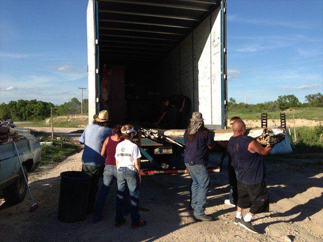 A group of people standing in front of a truck at Pine Ridge Reservation