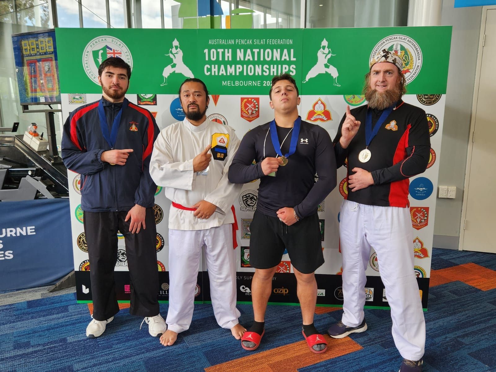 A group of men are standing in front of a sign that says 10th national championships.