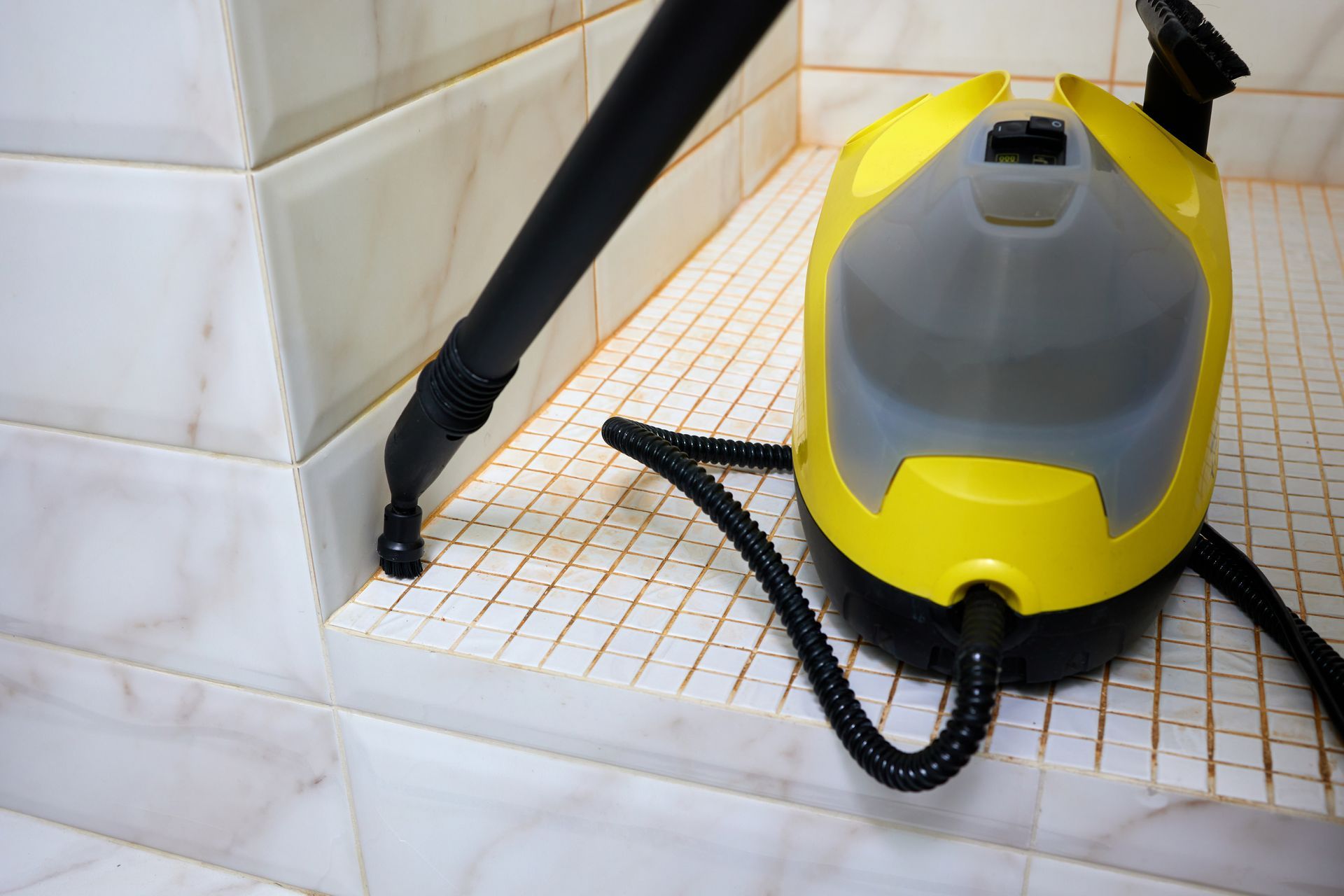 Yellow and Gray Steam Cleaner on Tiled Surface — Tampa, FL — A&A's Complete Services, Inc.