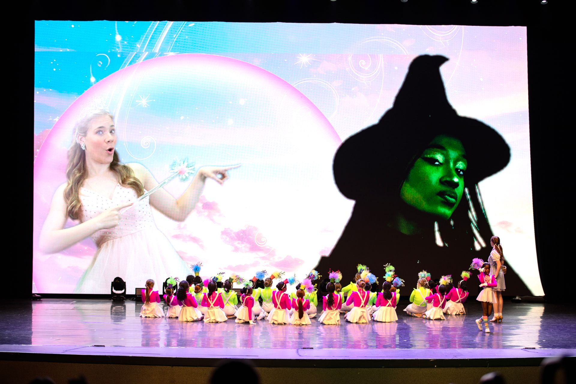 Elphaba and Glinda with munchkin dancers