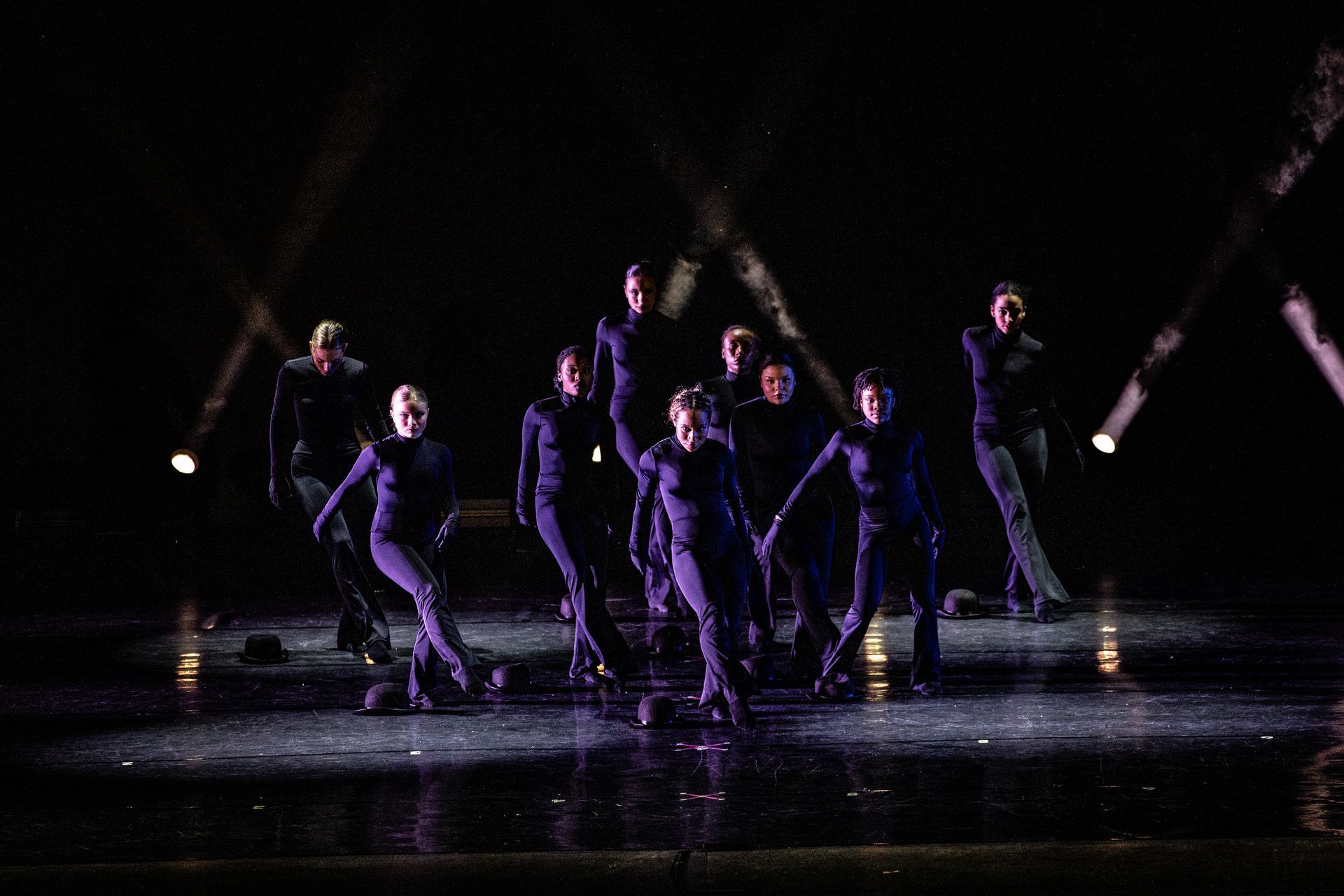 Older teen dancers in dark purple costumes