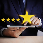 Hands using a tablet with a glowing five-star rating overlay
