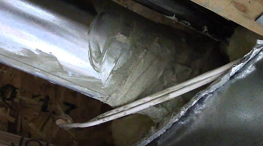 Technician repairing damaged ductwork to improve HVAC efficiency and air quality