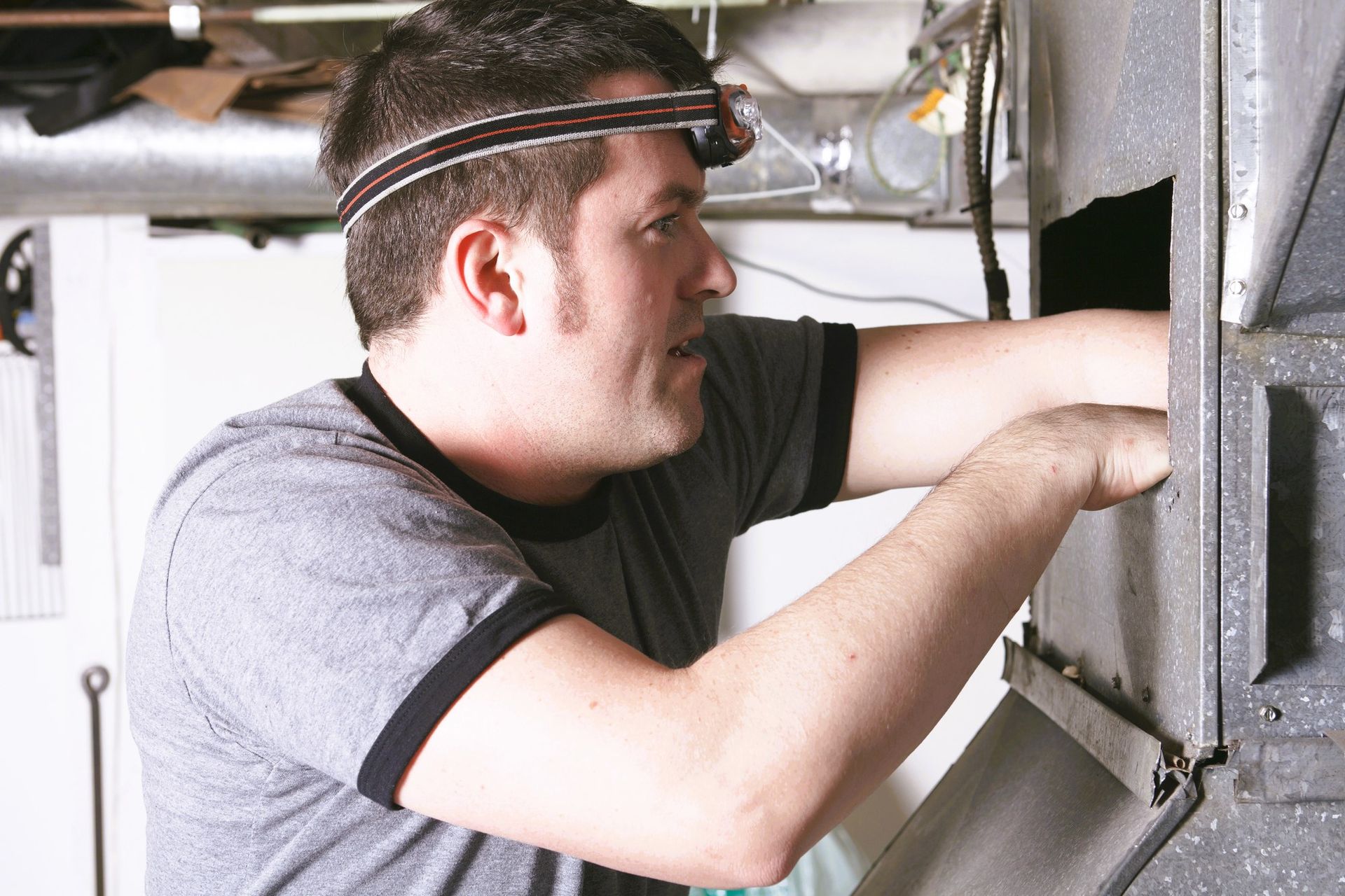 Expert performing air duct cleaning service