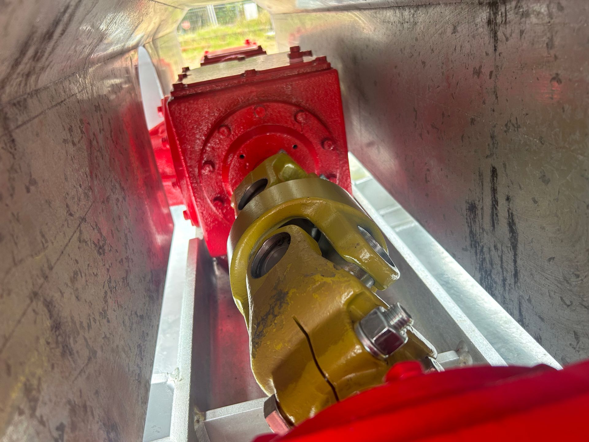 A person is looking down at a machine in a tunnel. — Wingham Farm Machinery in Wingham, NSW