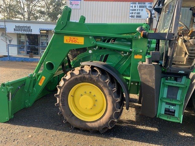 A John Deere Tractor is Parked in Front of a Building — Wingham Farm Machinery in Wingham, NSW