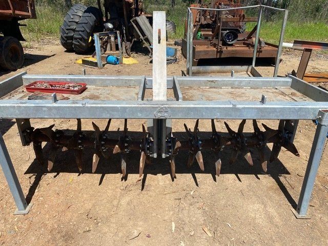 A Metal Frame With a Tractor in the Background  — Wingham Farm Machinery In Wingham, NSW