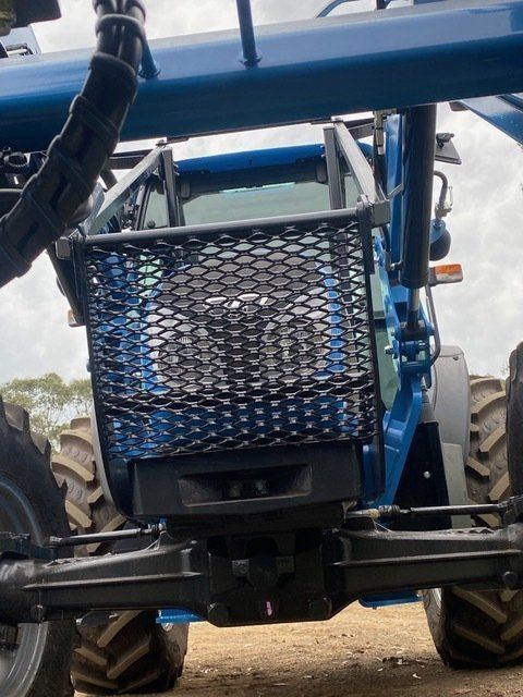A Blue Tractor With a Basket on the Front of It — Wingham Farm Machinery in Wingham, NSW