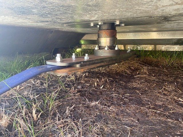 A Blue Hose is Attached to a Metal Bracket Under a Trailer — Wingham Farm Machinery In Wingham, NSW