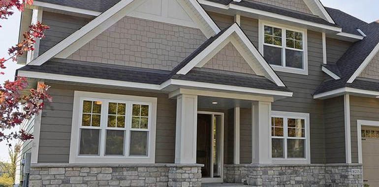 A large house with a lot of windows and a porch.