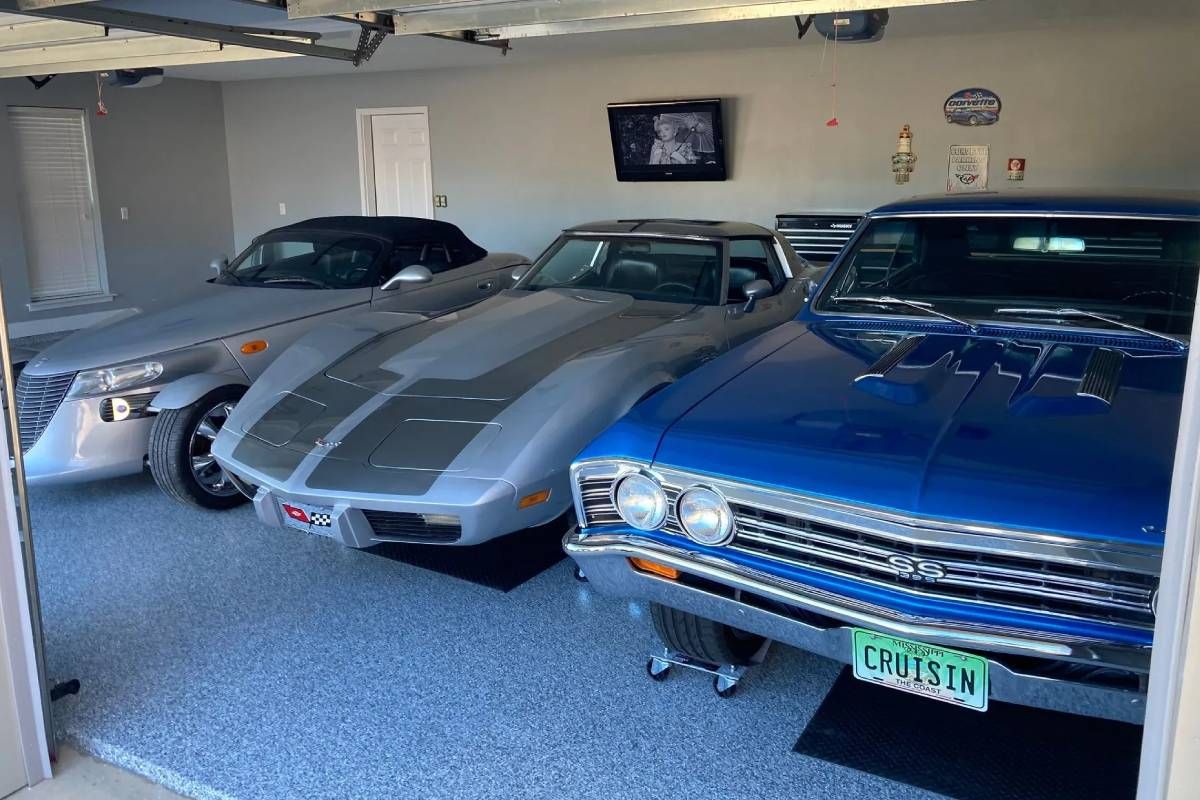 Garage with three cars featuring resinous flooring near Myrtle Beach, SC