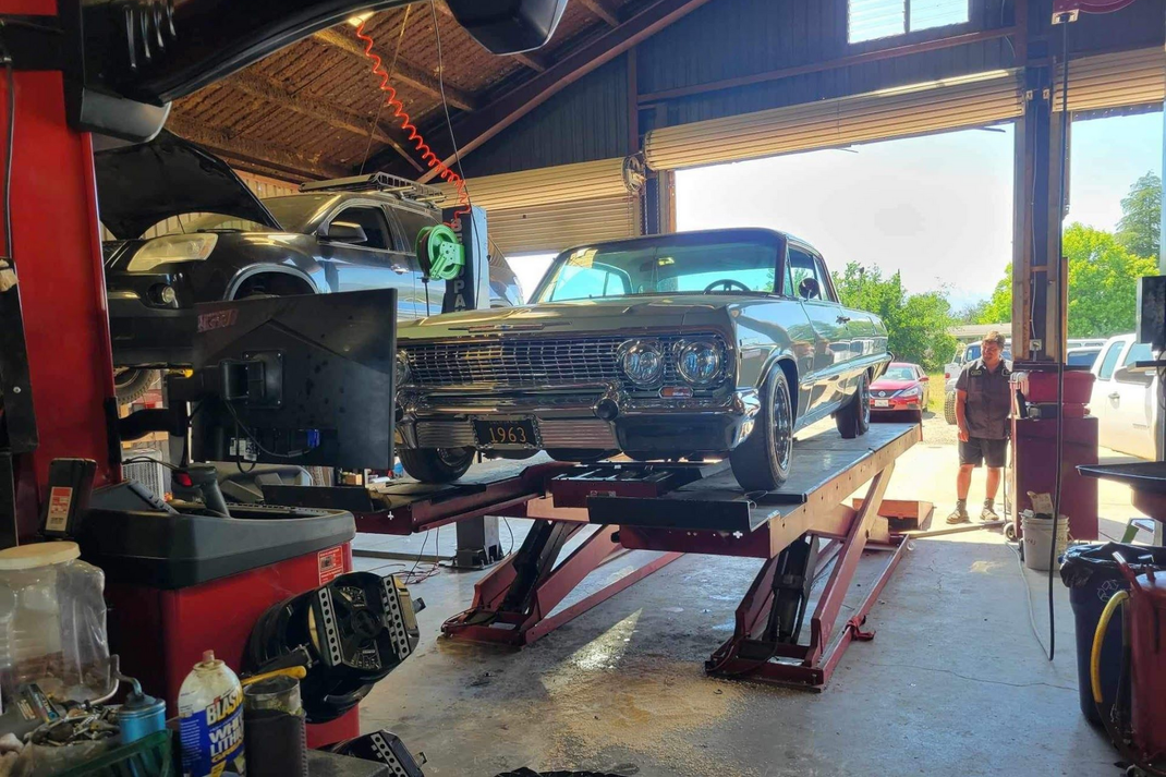 Classic Car on Hydraulic Lift Inside Auto Repair Shop | Chuy’s Garage
