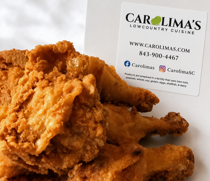 Fried chicken pieces on a white plate with a Carlina’s logo in the background