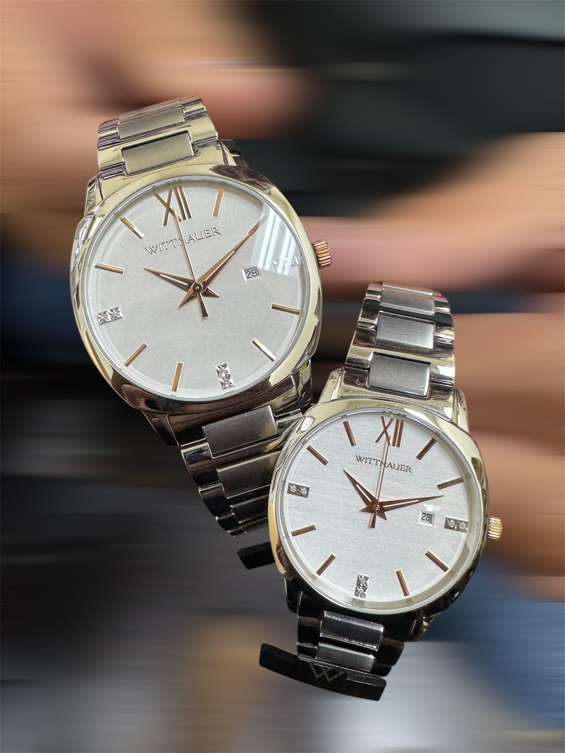 A person is holding two watches in their hands.