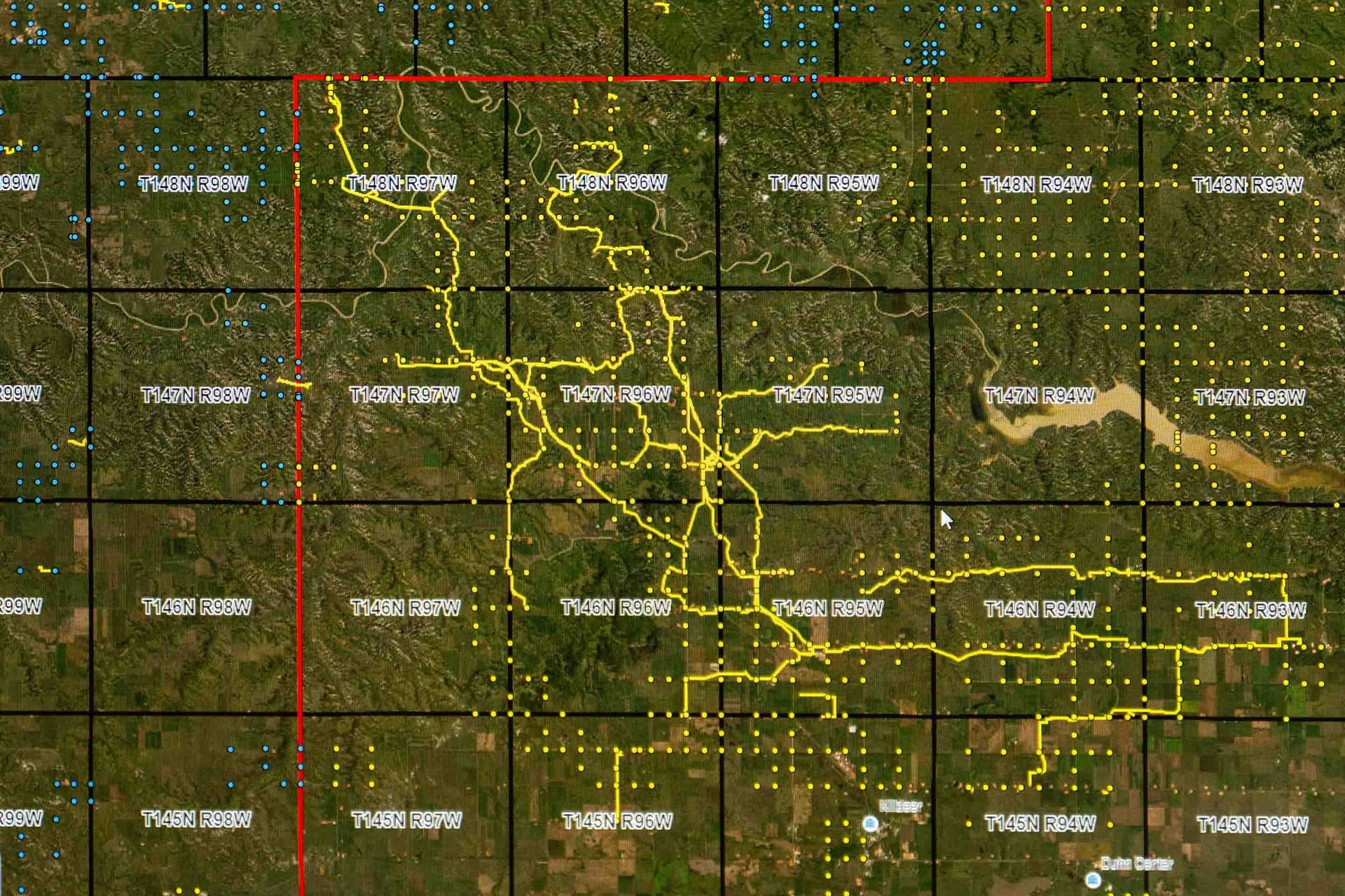 Overhead view map with yellow lines indicating infrastructure against a grid backdrop.