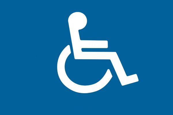 Image of a blue sign with a white pictogram of a person in a wheelchair, indicating accessibility.