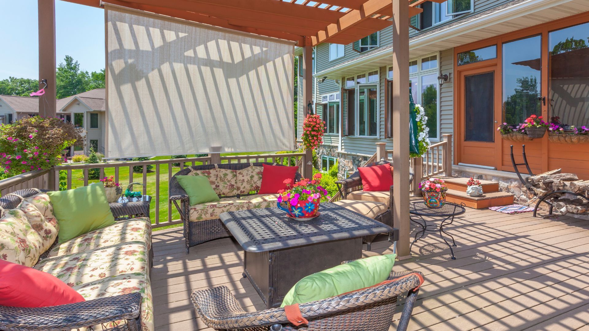 Cozy deck in Gilbert, AZ with floral cushions, pergola, and vibrant plants.