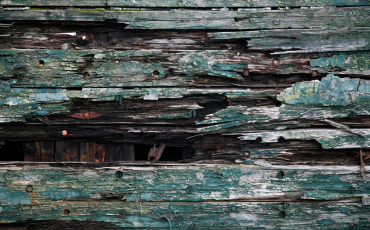 A photo of wood that is rotted away. The wood needs to be replaced.