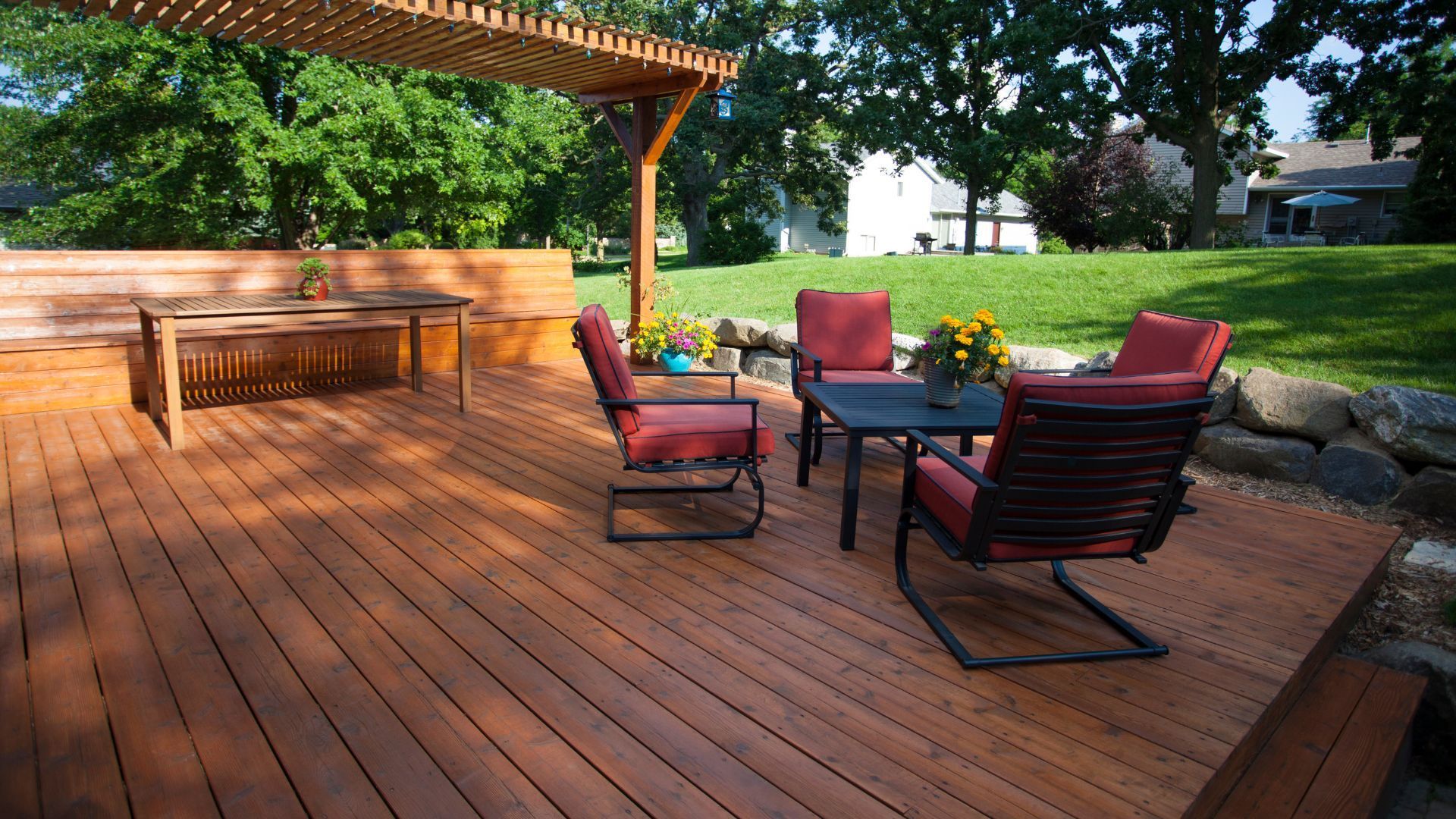 Spacious wooden deck with pergola and outdoor seating in Gilbert, AZ.