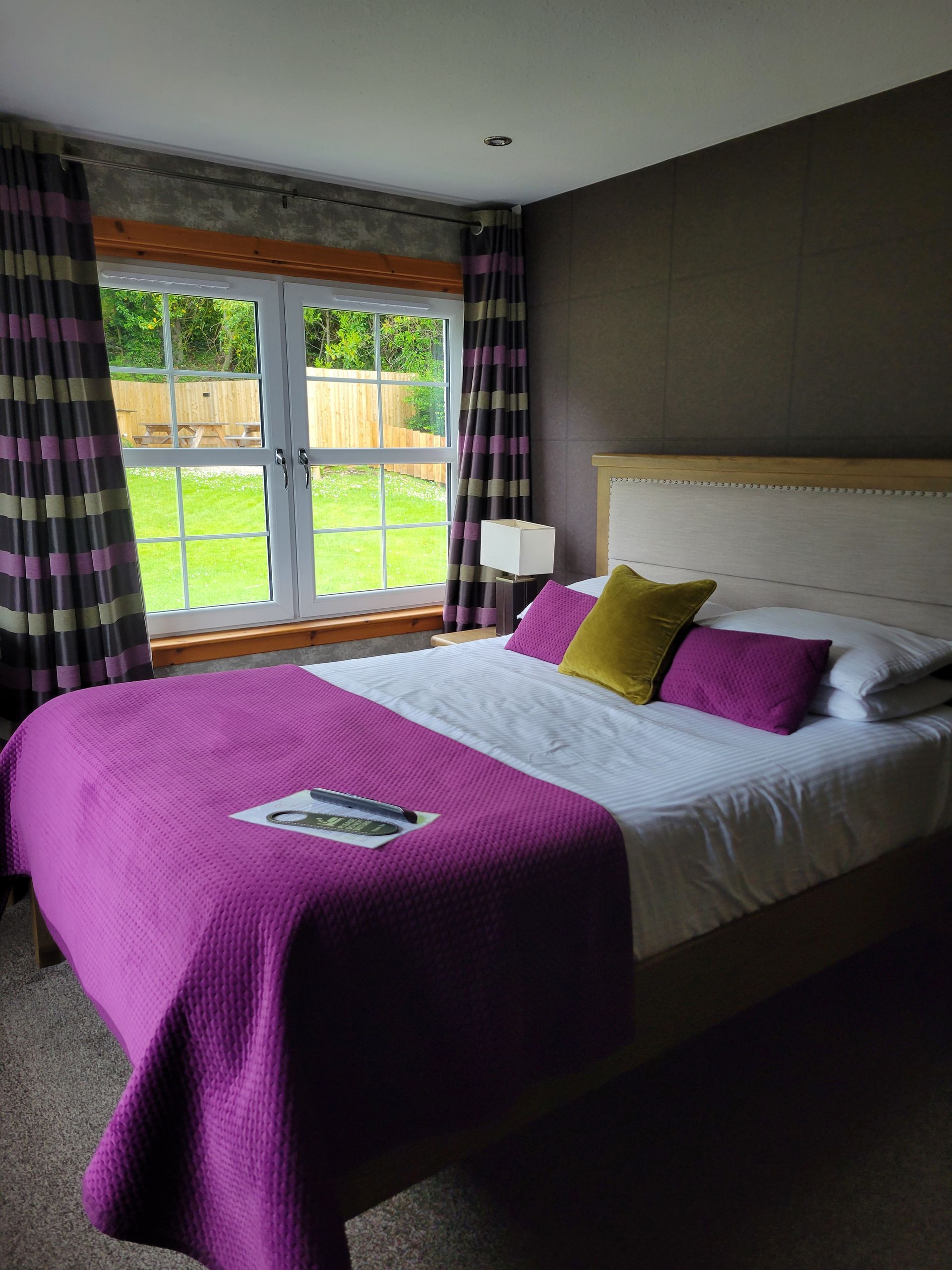 A bedroom with a large bed and a bathroom with a toilet.