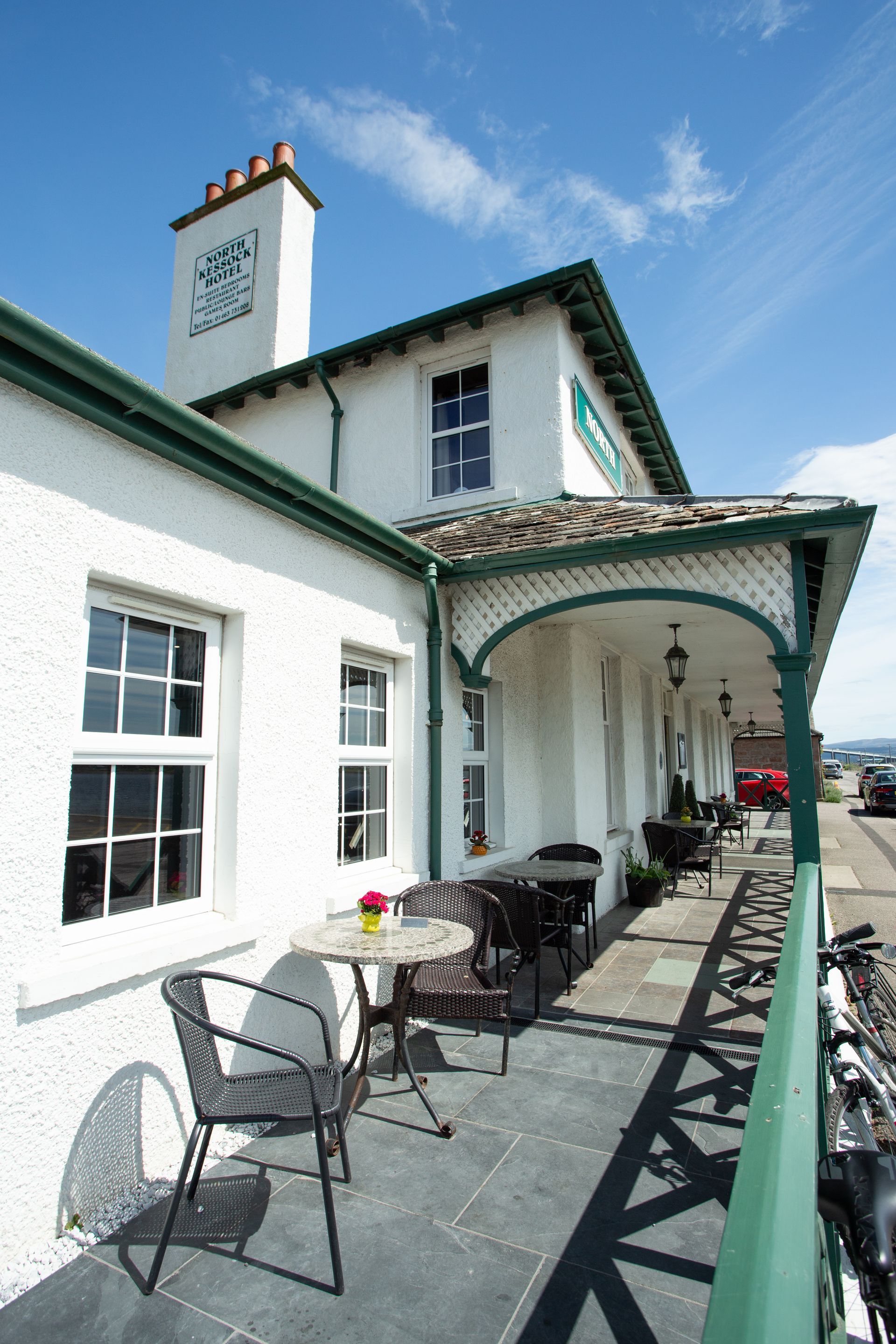 A white house with a clock on the side of it