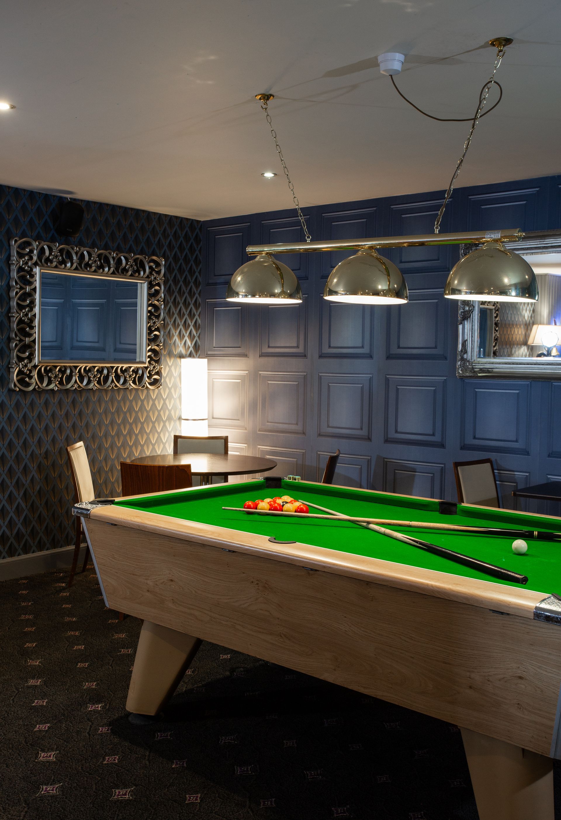 There is a pool table in the middle of the room.