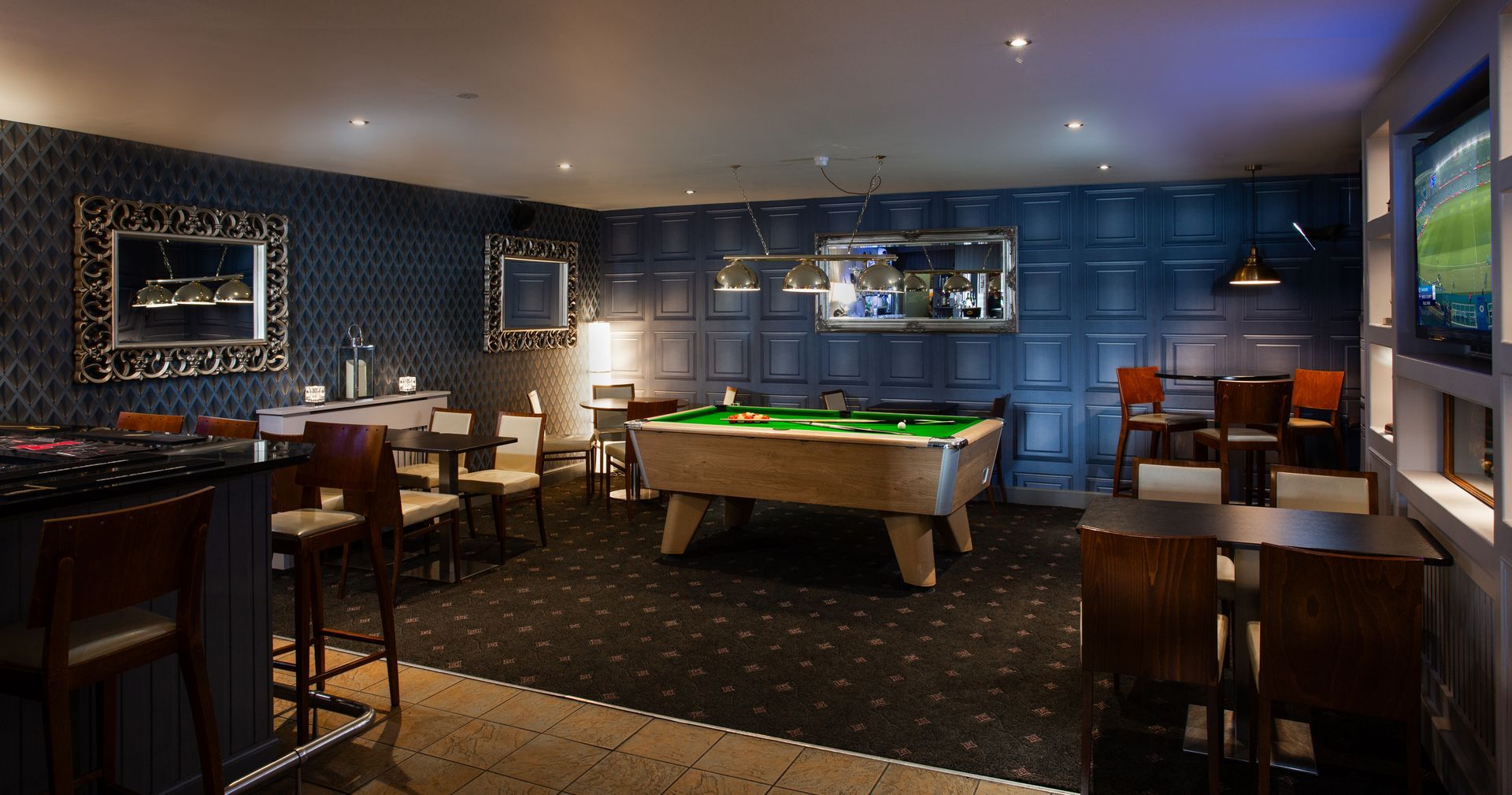 There is a pool table in the middle of the room.