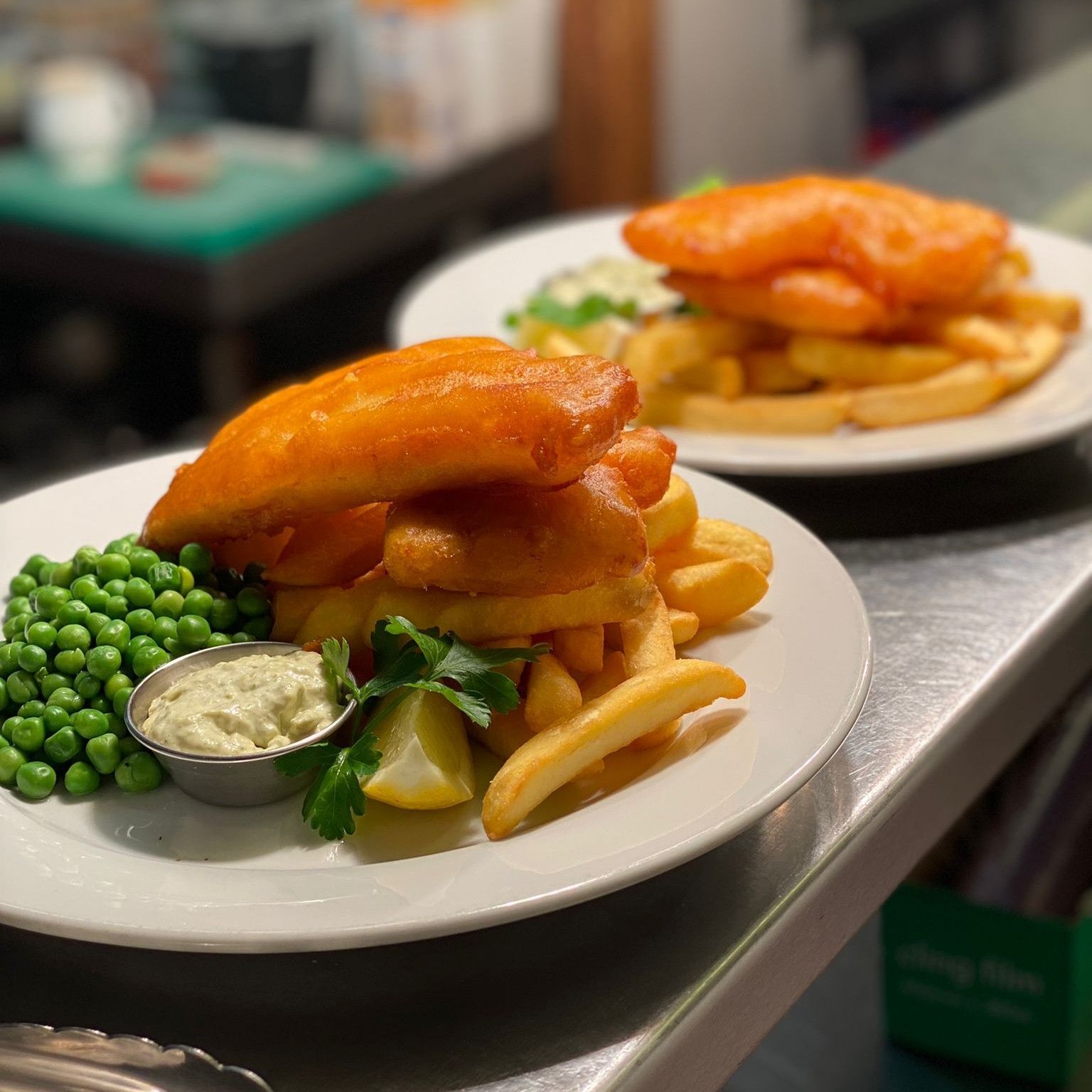 A plate of food with a hamburger and french fries on a table.