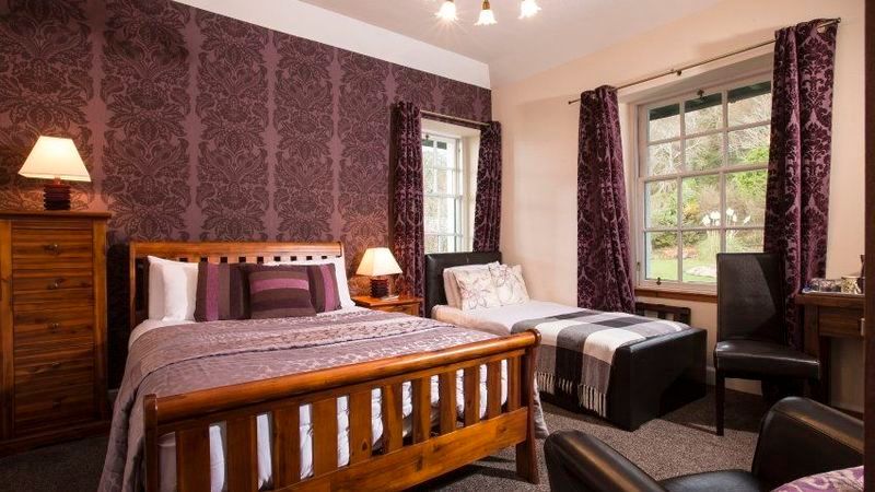 A bedroom with a king size bed and two twin beds.