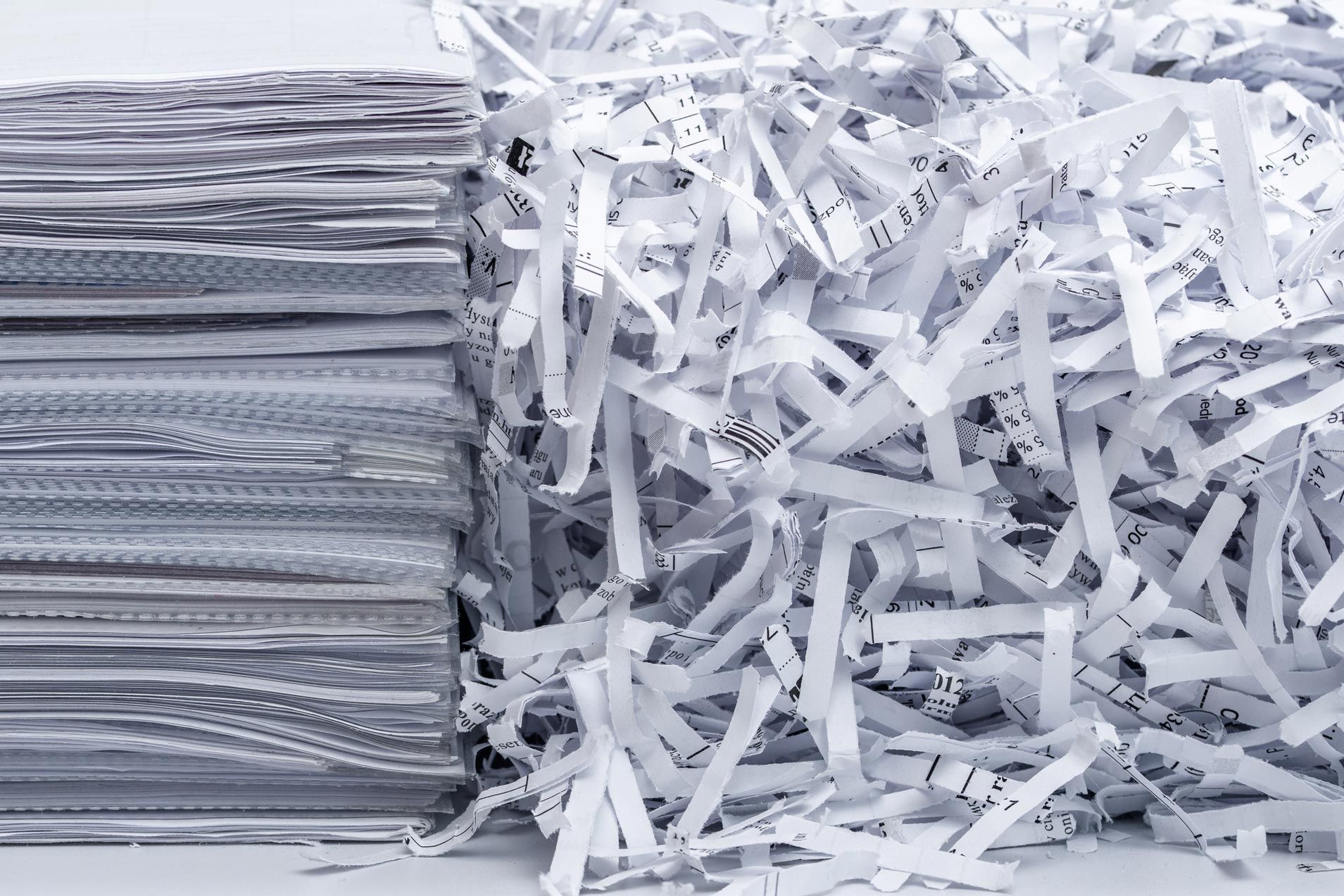 A pile of shredded paper next to a pile of shredded paper.