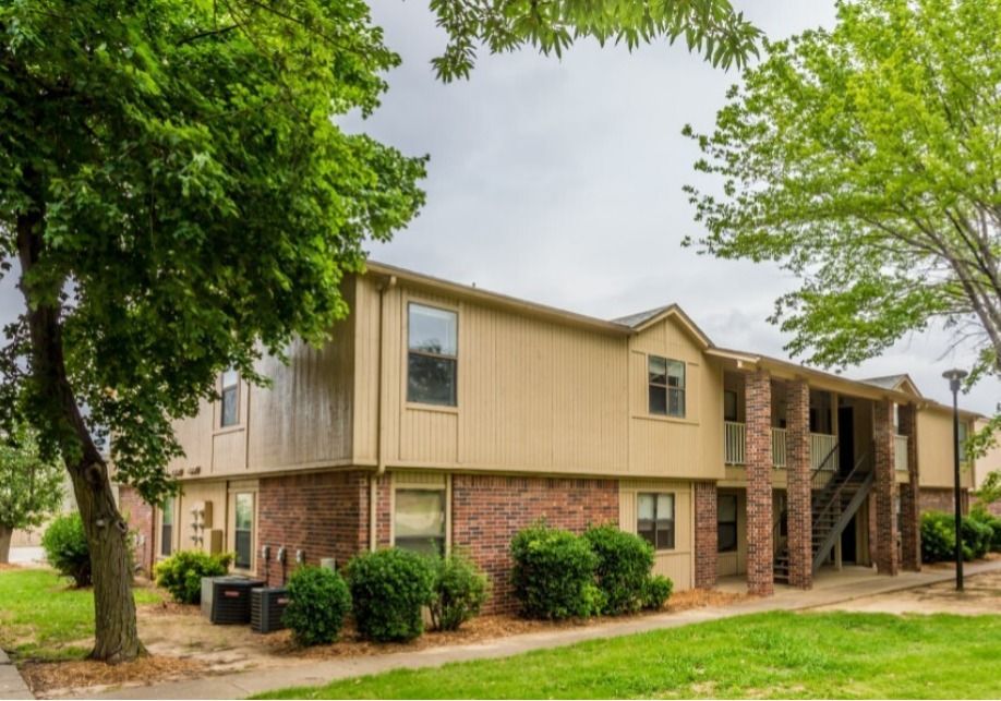 A house with a lot of windows and a tree in front of it