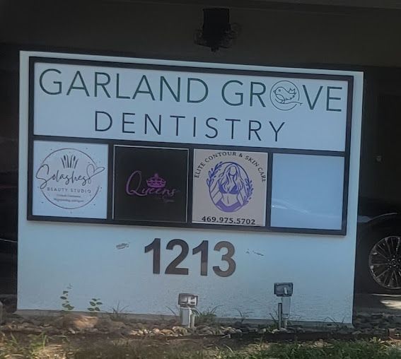 Sign for Garland Grove Dentistry at 1213 with logos for other businesses.