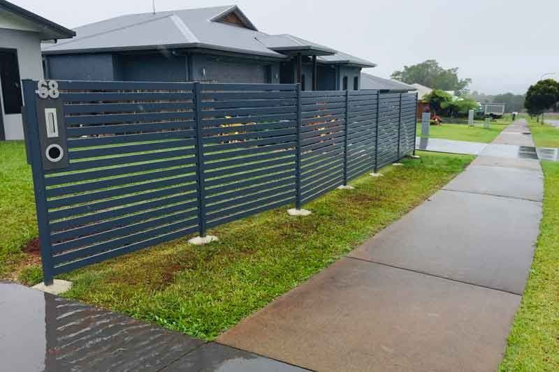 A Fence Along a Sidewalk in Front of a House — Fencing Around In Mareeba, QLD