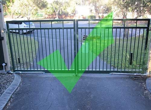 A Green Arrow is Pointing to a Gate That is Open — Fencing Around In Mareeba, QLD