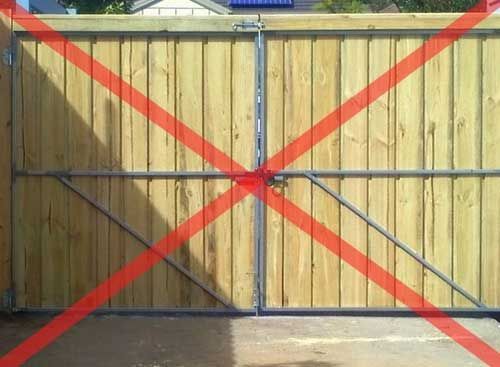 A Wooden Gate With a Red Cross Through It — Fencing Around In Mareeba, QLD
