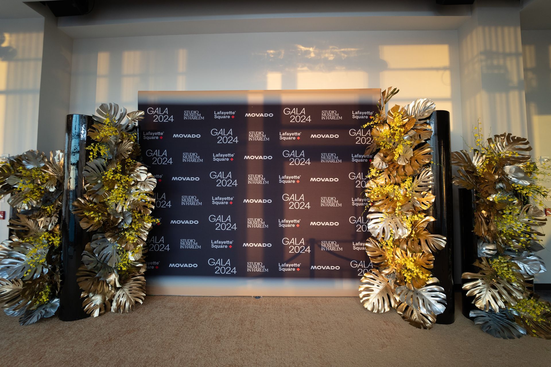 A stage with flowers and leaves in front of it