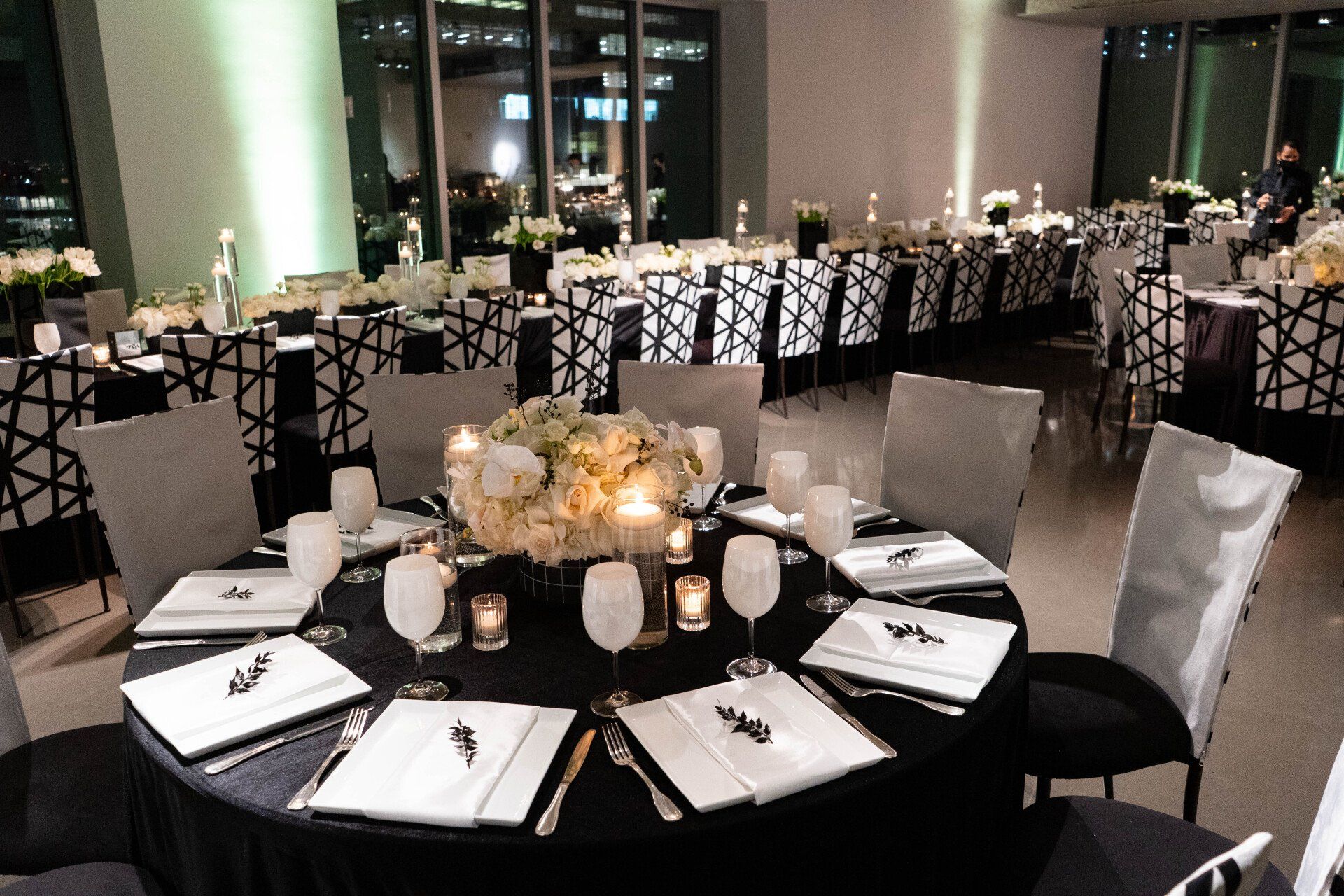 A large room with tables and chairs set up for a party
