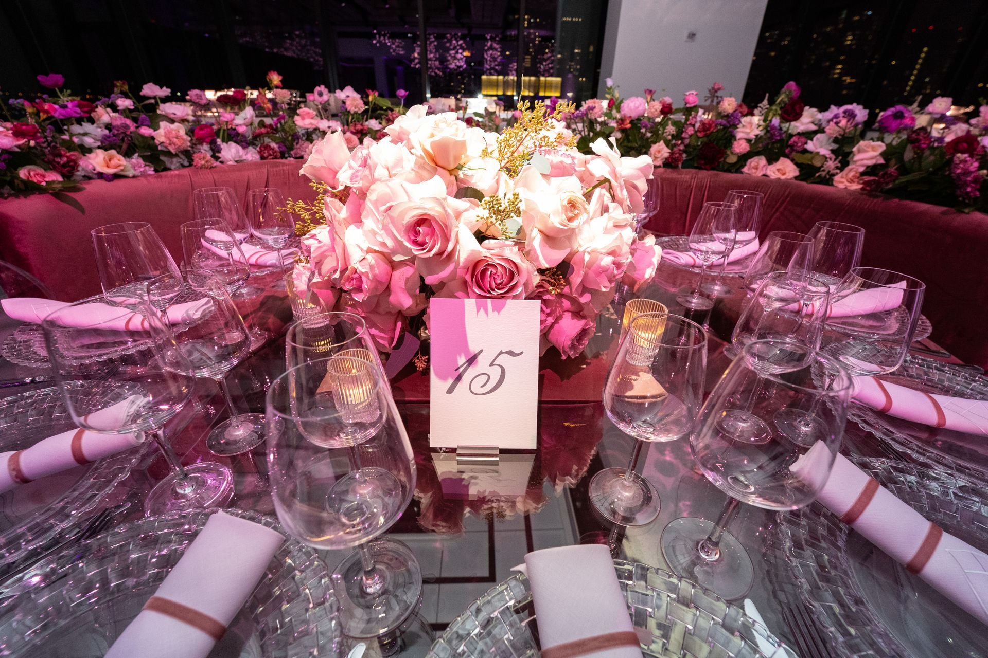 Elegant table setting with pink flowers, place settings, and a table number 15.