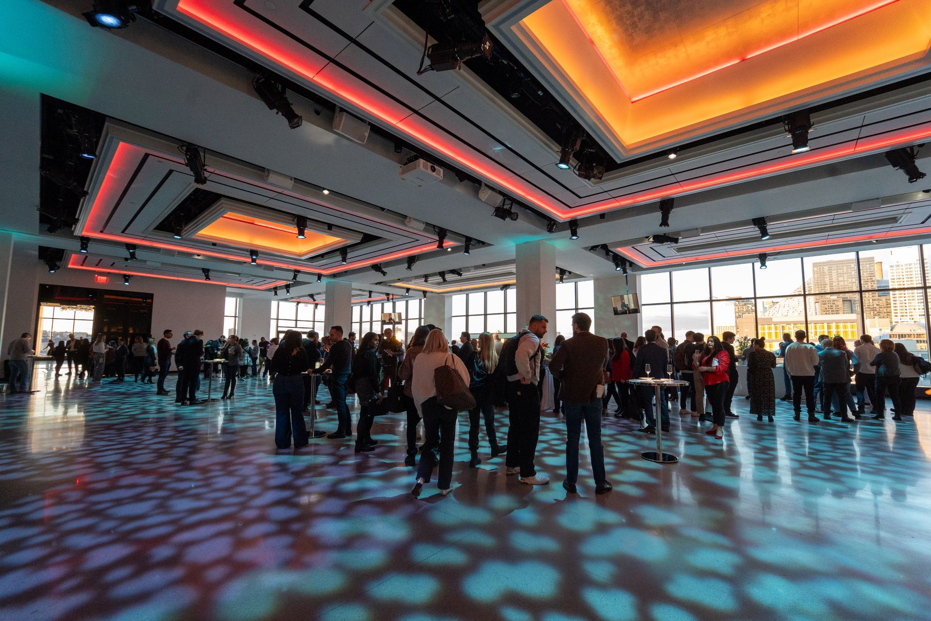 A group of people are standing in a large room.