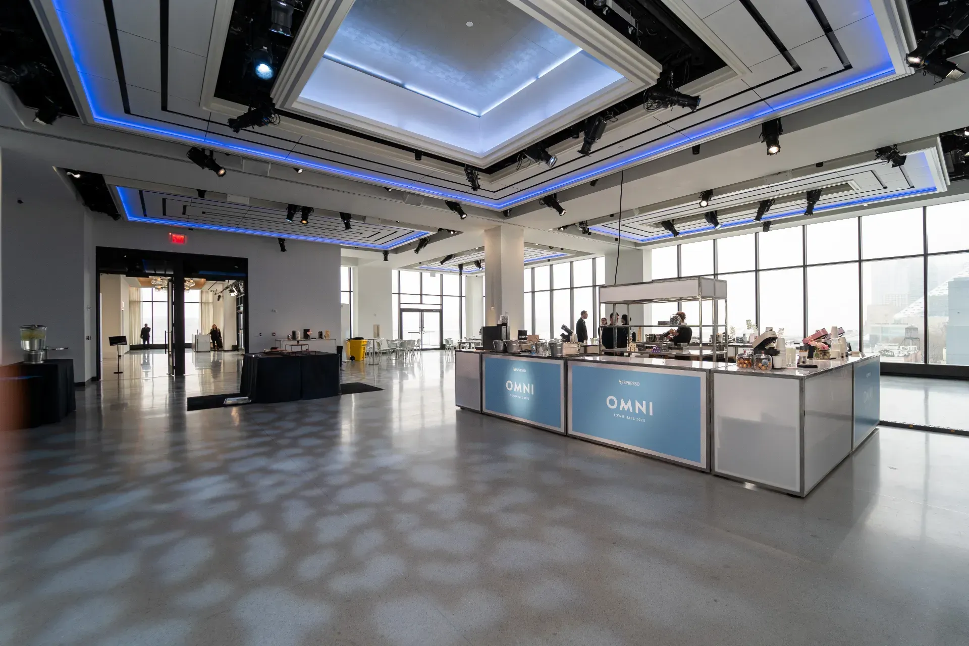 A large room with a lot of windows and tables in it.