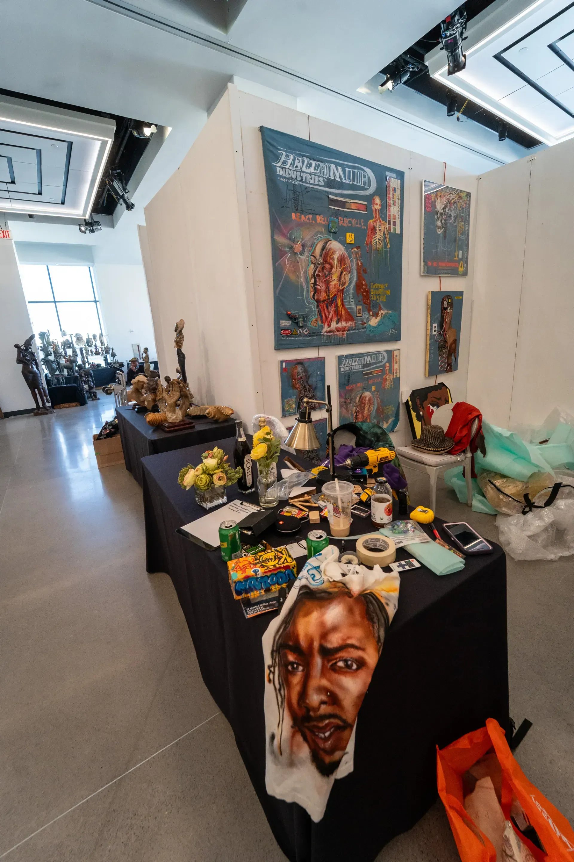 A table with a painting of a man 's face on it in a room.