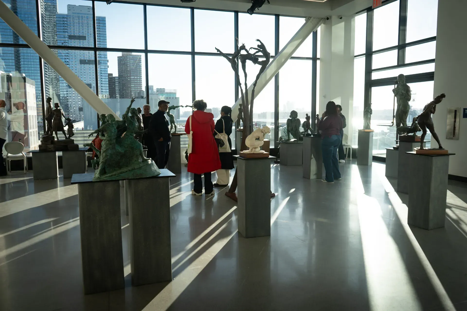 A group of people are looking at sculptures in a museum