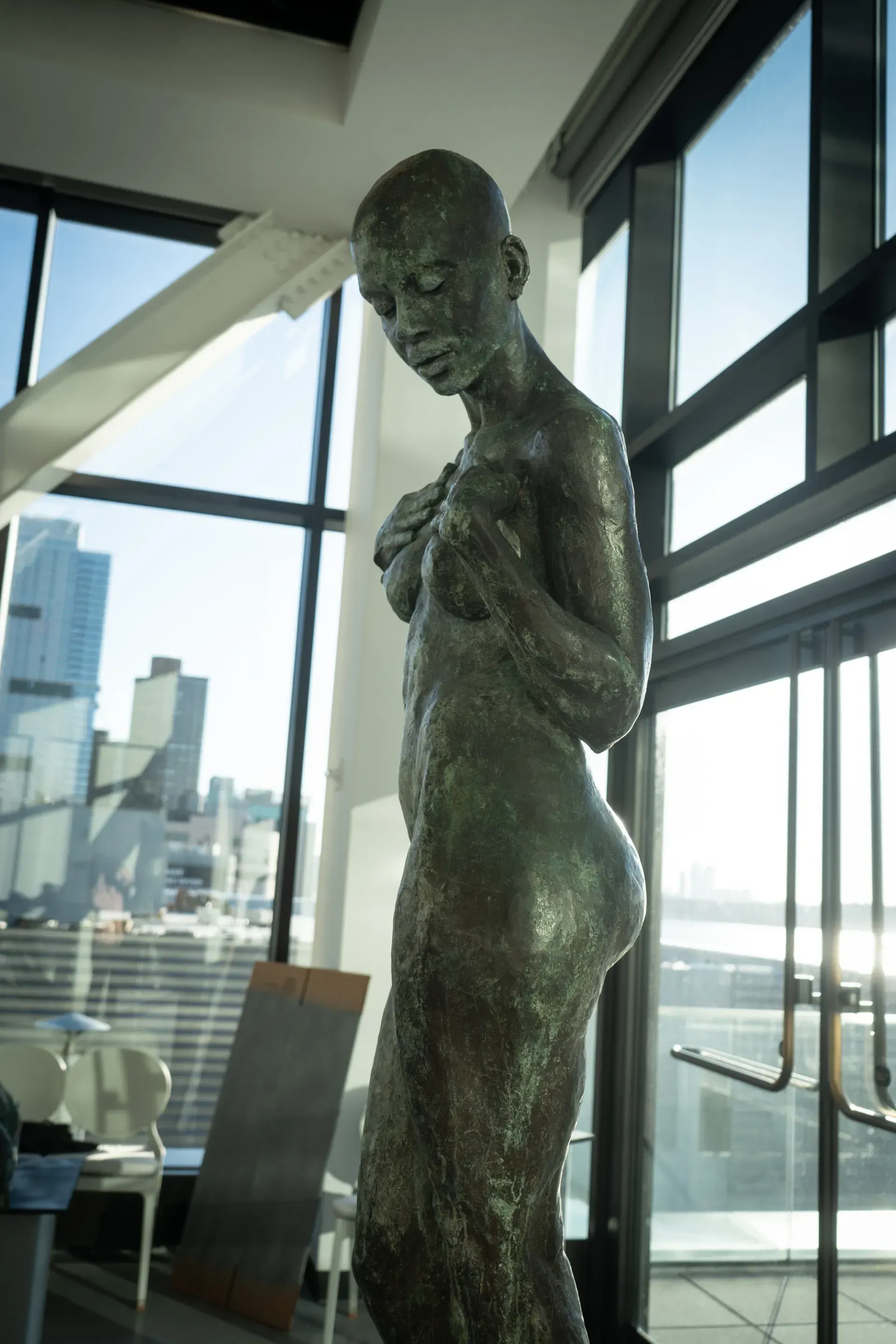A man and a woman are looking at a statue in a museum.