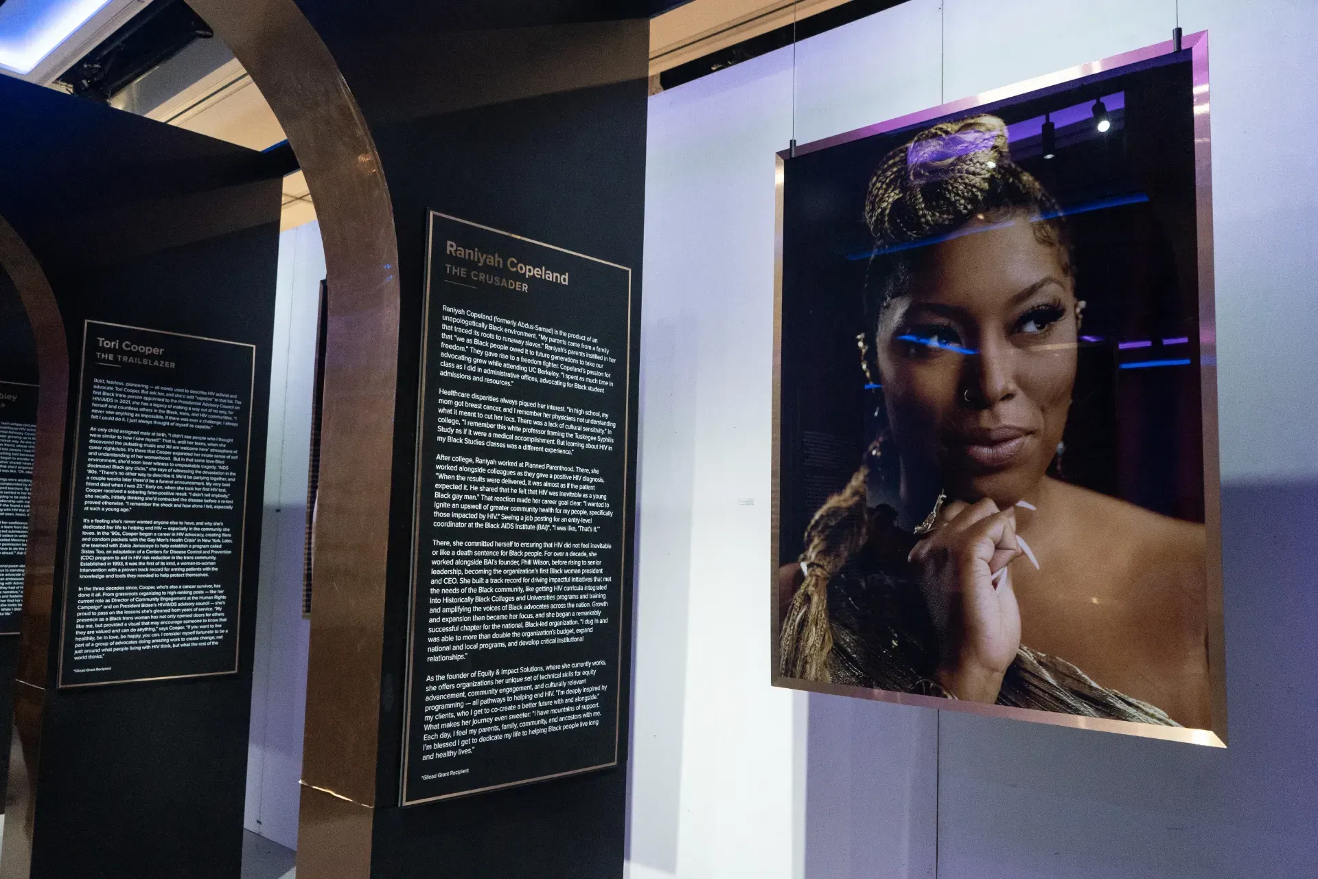 A picture of a woman is hanging on a wall